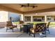 Relaxing outdoor patio with comfortable seating, ceiling fans, and views of the manicured lawn and surrounding landscape at 3927 E Vista Grande --, San Tan Valley, AZ 85140