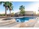 Sparkling pool with integrated spa and outdoor seating area, complemented by palm trees for a resort-style experience at 3927 E Vista Grande --, San Tan Valley, AZ 85140