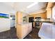 Well-lit kitchen with wood cabinets, an island, and stainless steel appliances, providing a practical and stylish cooking area at 4210 W Rosemonte Dr, Glendale, AZ 85308