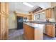 Functional kitchen featuring wood cabinets, an island, and modern appliances, perfect for everyday meals and entertaining at 4210 W Rosemonte Dr, Glendale, AZ 85308
