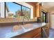 Bright kitchen sink area with a window view, updated fixtures, and ample countertop space for convenient food preparation at 4210 W Rosemonte Dr, Glendale, AZ 85308