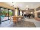 Cozy living room with a fireplace, tile flooring, and an adjacent patio, offering a comfortable and inviting space at 4210 W Rosemonte Dr, Glendale, AZ 85308