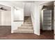 Basement area featuring carpeted stairs, brick floors, and access to storage space at 4225 N 21St St # 22, Phoenix, AZ 85016