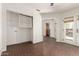 Living room area with brick floors, white walls, storage space, and glass doors with coverings at 4225 N 21St St # 22, Phoenix, AZ 85016