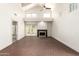 Sunlit living room featuring vaulted ceilings, fireplace, brick floors, and patio access at 4225 N 21St St # 22, Phoenix, AZ 85016
