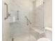 Frameless glass shower features modern fixtures, grab bars, and a built-in bench at 4225 N 21St St # 22, Phoenix, AZ 85016