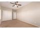 Spacious bedroom featuring neutral walls, carpet flooring, closet, and a ceiling fan at 45071 W Portabello Rd, Maricopa, AZ 85139
