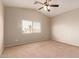 A light-filled bedroom features a ceiling fan and a window with blinds at 45071 W Portabello Rd, Maricopa, AZ 85139