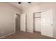 Bedroom featuring neutral walls, carpet flooring, closet, and an open doorway at 45071 W Portabello Rd, Maricopa, AZ 85139