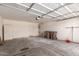 Spacious garage with concrete flooring, storage, and access door at 45071 W Portabello Rd, Maricopa, AZ 85139