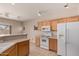 Well-lit kitchen features wood cabinets and appliances, with ample counter space at 45071 W Portabello Rd, Maricopa, AZ 85139