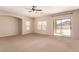 Spacious living room with plush carpeting, offering a comfortable and inviting atmosphere at 45071 W Portabello Rd, Maricopa, AZ 85139