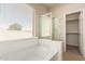 Main bathroom with soaking tub, glass shower, and window with blinds at 45071 W Portabello Rd, Maricopa, AZ 85139