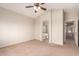 Spacious main bedroom with ceiling fan, archway to bathroom and view of hallway at 45071 W Portabello Rd, Maricopa, AZ 85139
