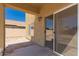 A covered patio with a sliding glass door that offers an outdoor living space at 45071 W Portabello Rd, Maricopa, AZ 85139