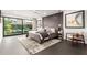 Bedroom featuring neutral colors, modern decor, large windows, and a sitting chair at 4835 E Onyx Ave, Paradise Valley, AZ 85253