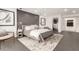 A spacious primary bedroom featuring large windows, neutral decor, and a sitting chair at 4835 E Onyx Ave, Paradise Valley, AZ 85253