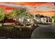 Elegant home with beautiful landscape lighting, lush greenery, and a circular driveway at twilight at 4835 E Onyx Ave, Paradise Valley, AZ 85253