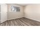 Cozy bedroom features wood-look laminate flooring and a window for natural light at 520 N Stapley Dr # 257, Mesa, AZ 85203