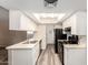 Kitchen with white cabinets, stainless sink, black appliances and modern wood-style flooring at 520 N Stapley Dr # 257, Mesa, AZ 85203