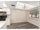 Kitchen with breakfast bar, black appliances and wood-style flooring and eat-in dining space at 520 N Stapley Dr # 257, Mesa, AZ 85203