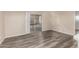 Living room featuring wood-style flooring, neutral paint, sliding glass door to balcony at 520 N Stapley Dr # 257, Mesa, AZ 85203