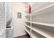 Pantry next to stacked washer and dryer features lots of shelving for organized storage at 520 N Stapley Dr # 257, Mesa, AZ 85203