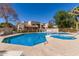 Community pool with inviting blue water, lounge chairs, and nearby landscaped community buildings at 520 N Stapley Dr # 257, Mesa, AZ 85203