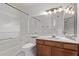 Bathroom featuring a bathtub, toilet, vanity with solid surface countertop and decorative lighting at 533 W Guadalupe Rd # 2126, Mesa, AZ 85210