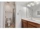 Bathroom showcasing a walk-in shower, toilet, vanity with solid surface countertop and decorative lighting at 533 W Guadalupe Rd # 2126, Mesa, AZ 85210