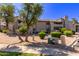 Two-story condo building with landscaped yard, desert landscaping, and beige stucco exterior at 533 W Guadalupe Rd # 2126, Mesa, AZ 85210