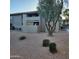 The exterior of this charming condo features desert landscaping and a mature shade tree at 533 W Guadalupe Rd # 2126, Mesa, AZ 85210