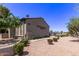 Beige Woodglen Square condo building with desert landscaping and common parking area at 533 W Guadalupe Rd # 2126, Mesa, AZ 85210
