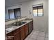 Kitchen with stainless steel appliances, wood cabinets, and a breakfast bar overlooking another room at 533 W Guadalupe Rd # 2126, Mesa, AZ 85210