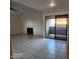 Bright living room with tile floors, a fireplace, and a sliding glass door leading to a patio at 533 W Guadalupe Rd # 2126, Mesa, AZ 85210