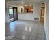 Open-concept living room featuring tile floors, sliding glass doors, and a breakfast bar overlooking the kitchen at 533 W Guadalupe Rd # 2126, Mesa, AZ 85210