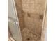 Shower stall tiled in decorative earth-toned tiles with glass doors and metallic trim at 533 W Guadalupe Rd # 2126, Mesa, AZ 85210