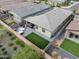Aerial view of a backyard with outdoor dining, artificial turf, and a well-kept property at 5871 N 187Th Ln, Litchfield Park, AZ 85340