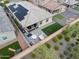 Aerial view of a backyard with a patio, artificial grass, and solar panels on the roof at 5871 N 187Th Ln, Litchfield Park, AZ 85340