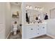 Bathroom with dual sinks, a large mirror, and stylish fixtures with tile flooring at 5871 N 187Th Ln, Litchfield Park, AZ 85340