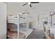 Bedroom with bunkbeds, closet and access to the hallway and desk area with modern chair at 5871 N 187Th Ln, Litchfield Park, AZ 85340