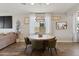 Cozy dining area with a round table, stylish chairs, and a woven pendant light fixture at 5871 N 187Th Ln, Litchfield Park, AZ 85340