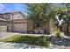 Beautiful single-story home with lush landscaping, stone accents, and a two-car garage at 5871 N 187Th Ln, Litchfield Park, AZ 85340