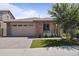 Charming single-story home with well-maintained landscaping, brick accents, and a two-car garage at 5871 N 187Th Ln, Litchfield Park, AZ 85340