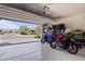 Spacious garage featuring two motorcycles with shelving and plenty of storage space at 5871 N 187Th Ln, Litchfield Park, AZ 85340