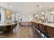 Open-concept kitchen features a breakfast bar with seating and modern décor throughout the living space at 5871 N 187Th Ln, Litchfield Park, AZ 85340
