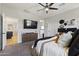 Comfortable main bedroom featuring a ceiling fan, TV, and neutral colors for a cozy space at 5871 N 187Th Ln, Litchfield Park, AZ 85340