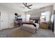 Serene main bedroom with neutral tones, a ceiling fan, an office nook, and natural light from the windows at 5871 N 187Th Ln, Litchfield Park, AZ 85340