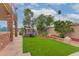 Spacious backyard with artificial turf, patio furniture, and mature landscaping at 5940 W Robinson Way, Chandler, AZ 85226
