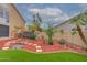 Backyard displaying decorative bridge, garden area, artificial turf, and lush landscaping at 5940 W Robinson Way, Chandler, AZ 85226